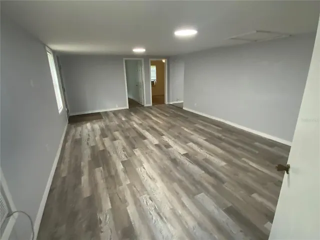 a view of an empty room and wooden floor