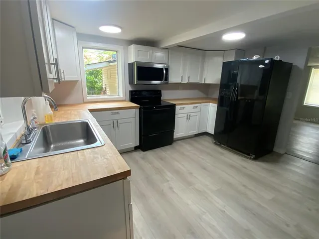 a kitchen with a refrigerator sink and microwave