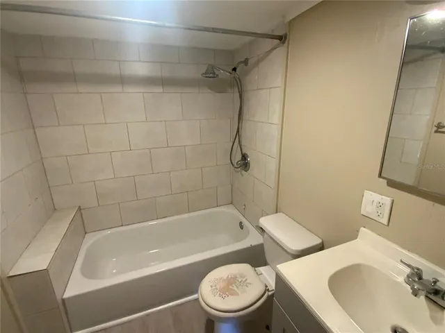 a bath room with a toilet sink and a bath tub
