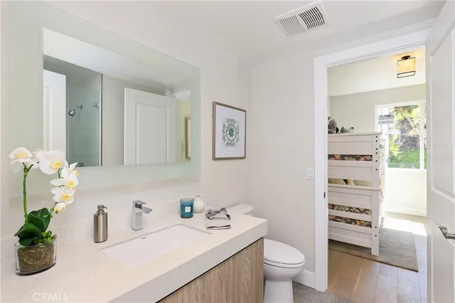 a bedroom with a bed and a potted plant