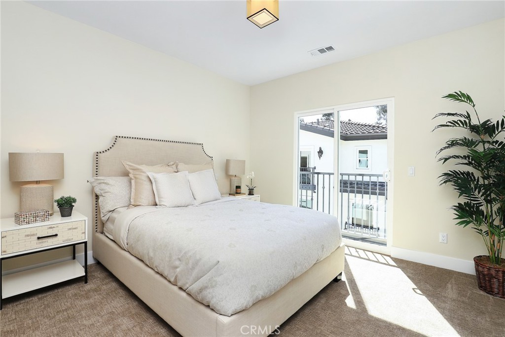 6 Bethpage Lane Phillips Ranch, CA 91766 - Photo 22 of 63 a bedroom with a large bed and a potted plant