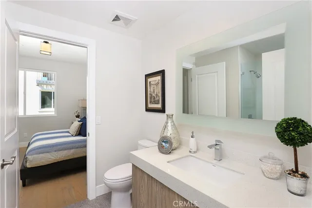 a spacious bathroom with a granite countertop tub sink and mirror