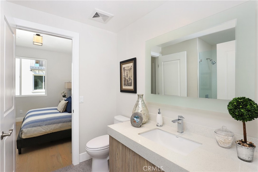 6 Bethpage Lane Phillips Ranch, CA 91766 - Photo 35 of 63 a bathroom with a granite countertop toilet sink and mirror