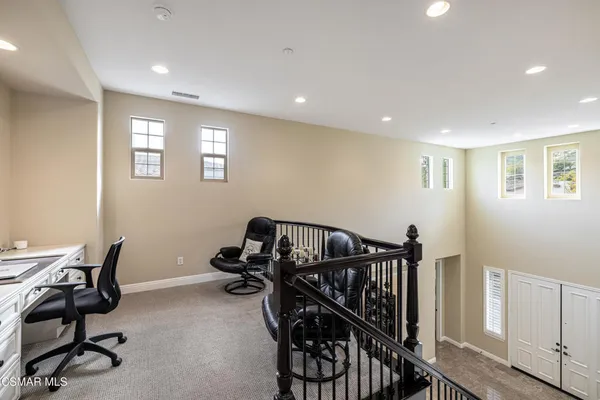 a view of a workspace with furniture and white walls