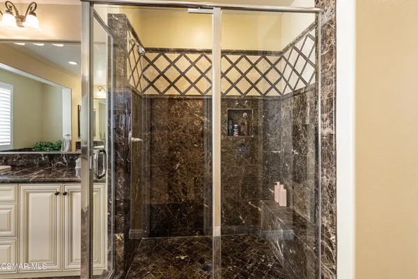 a bathroom with a shower and a sink