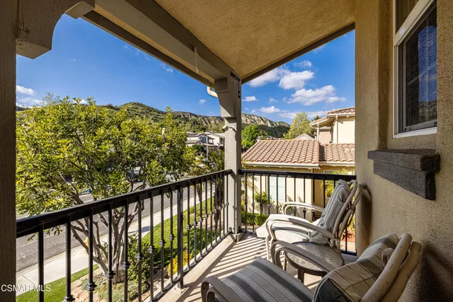 a view of a two chairs in the balcony