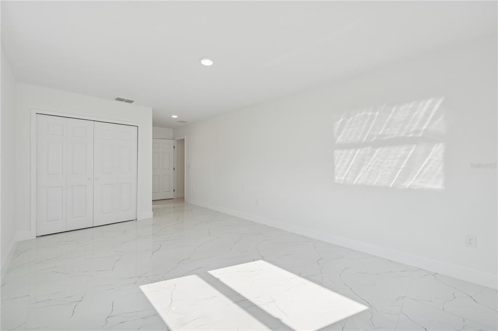 4033 Buttonbush Circle Lakeland, FL 33811 - Photo 17 of 33 an empty room with a white cabinet and door