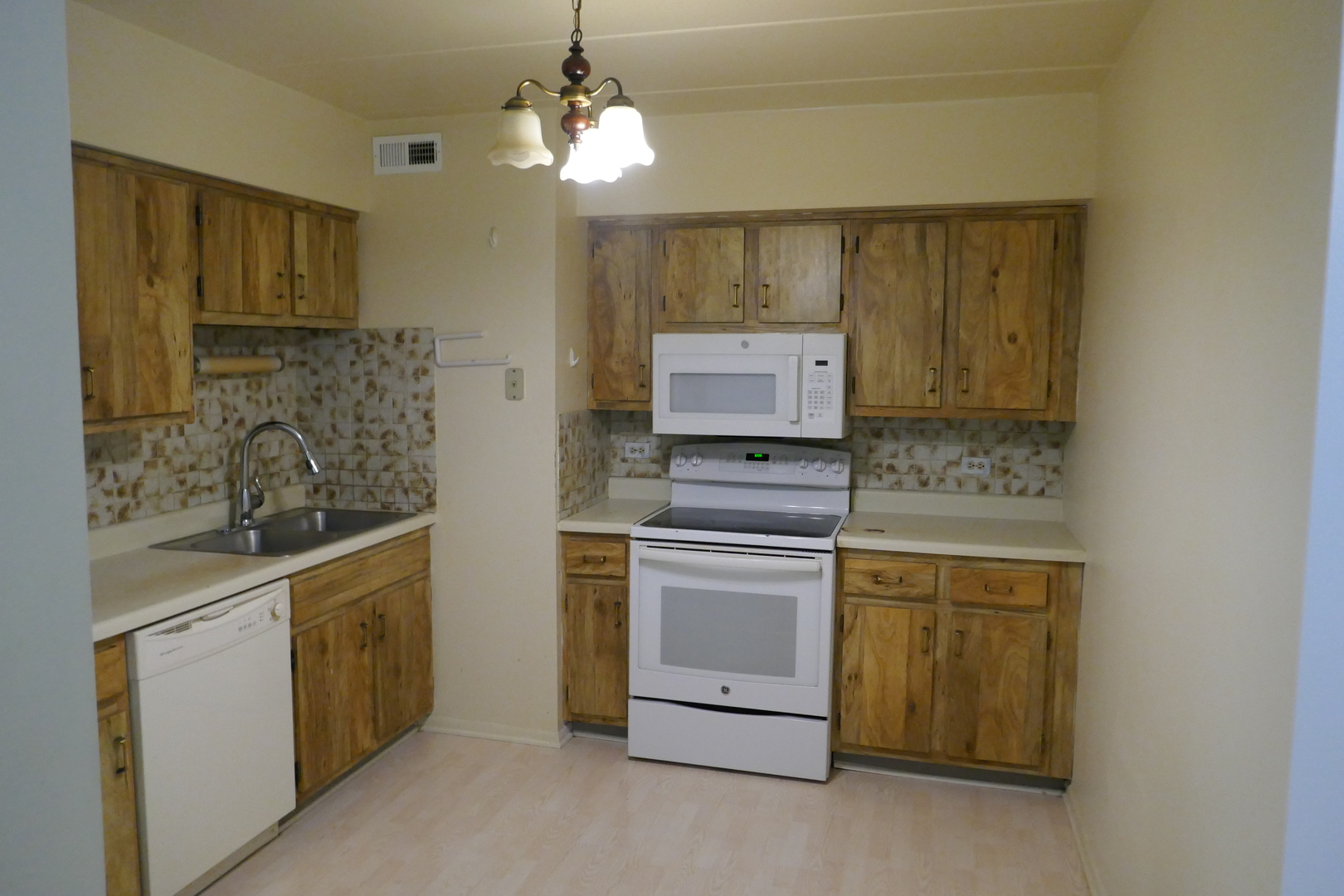 603 South River Road, Unit 2M Des Plaines, IL 60016 - Photo 8 of 20 a kitchen with stainless steel appliances granite countertop a stove and a sink