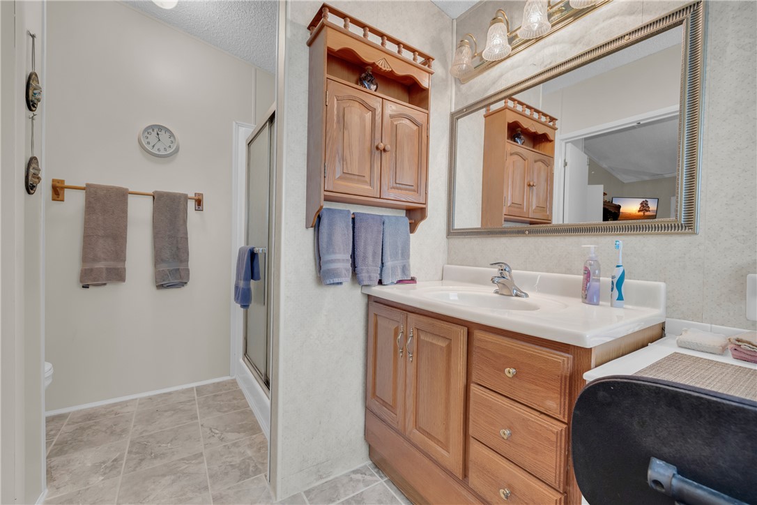 721 Cedar Crest Trail Walhalla, SC 29691 - Photo 19 of 47 A well-lit bathroom features a vanity with ample storage and a clear shower enclosure.
