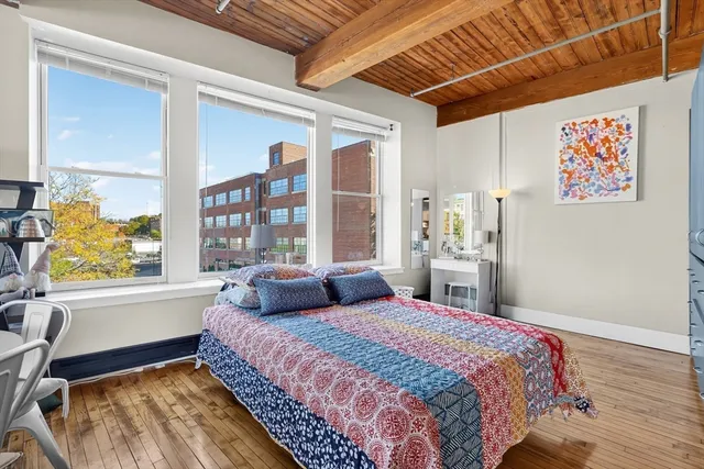 a bedroom with a large bed and a window