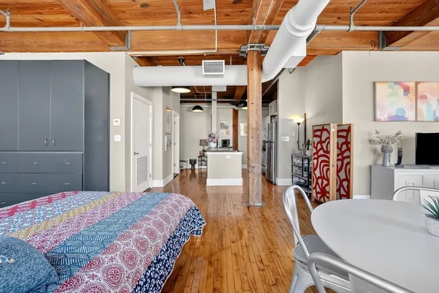 a bedroom with a large bed and a walk in closet