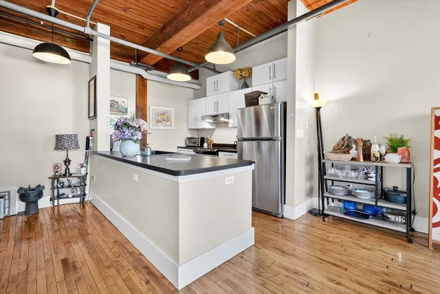 a kitchen with refrigerator and cabinets