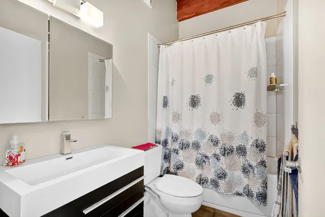 a bathroom with a sink toilet and shower