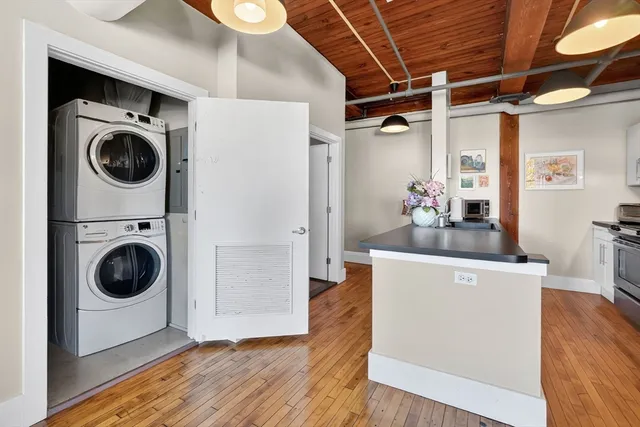 a view of a storage and utility room with wooden floor
