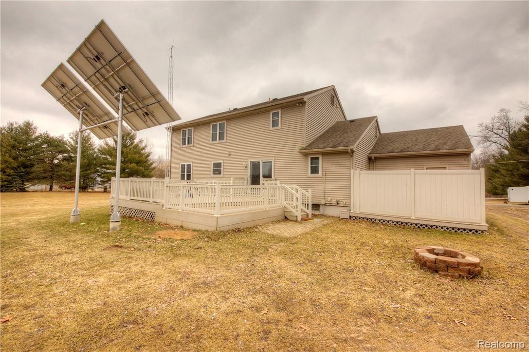 9213 Coleman Road Haslett, MI 48840 - Photo 56 of 99 Rear of Home, Solar Panels and Fenced in Hot Tub Behind the garage