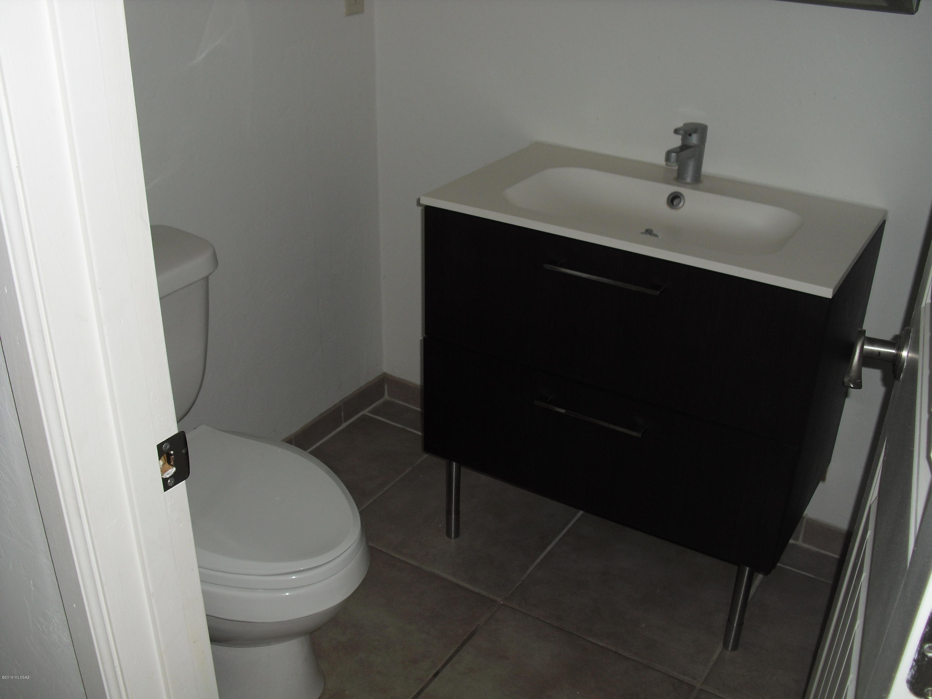 402 Hopkins Street Rio Rico, AZ 85648 - Photo 9 of 14 a bathroom with a sink and a toilet