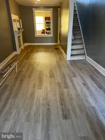 wooden floor in an empty room with a fireplace