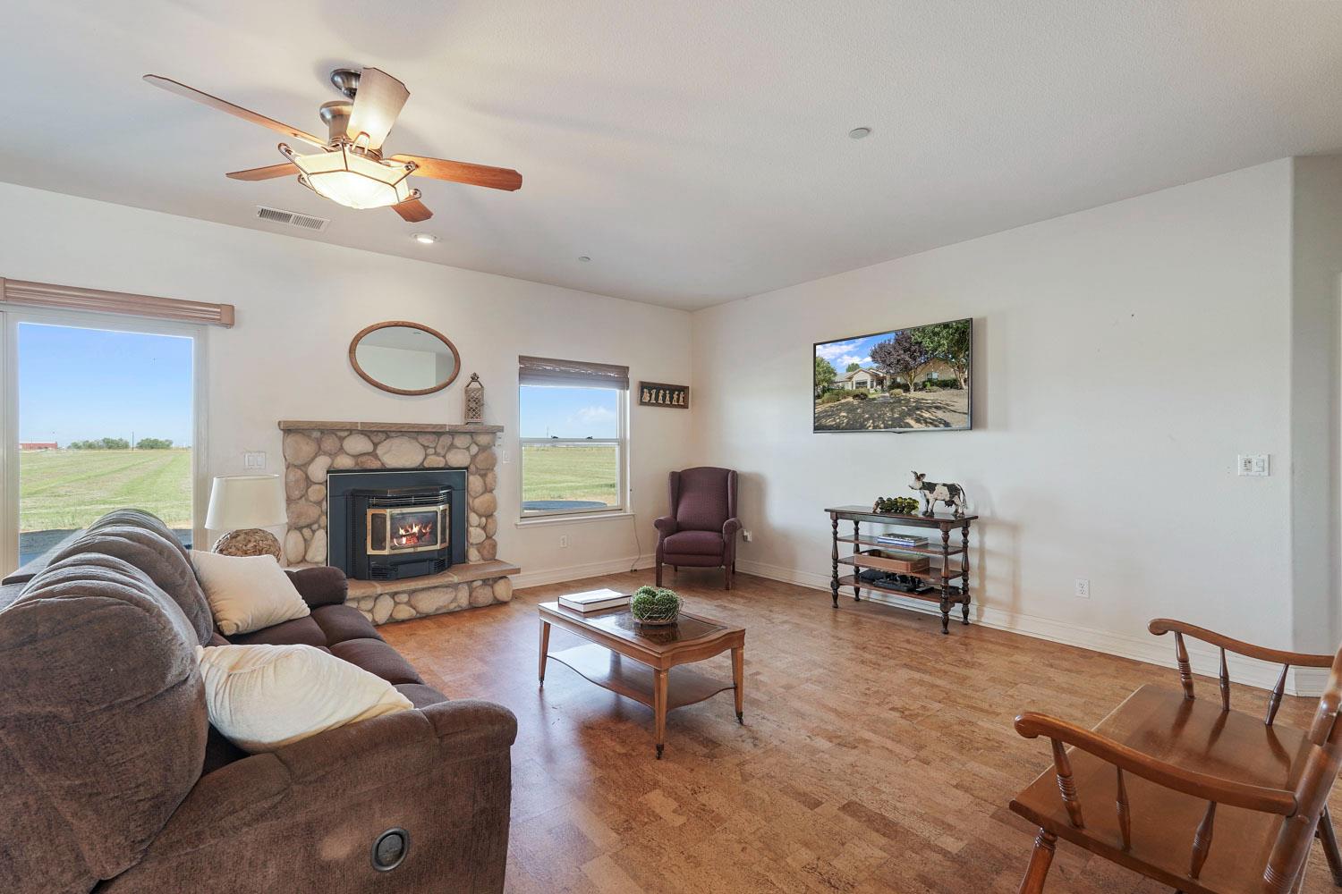 6120 Eschinger Road Elk Grove, CA 95757 - Photo 11 of 39 a living room with furniture a fireplace and a window