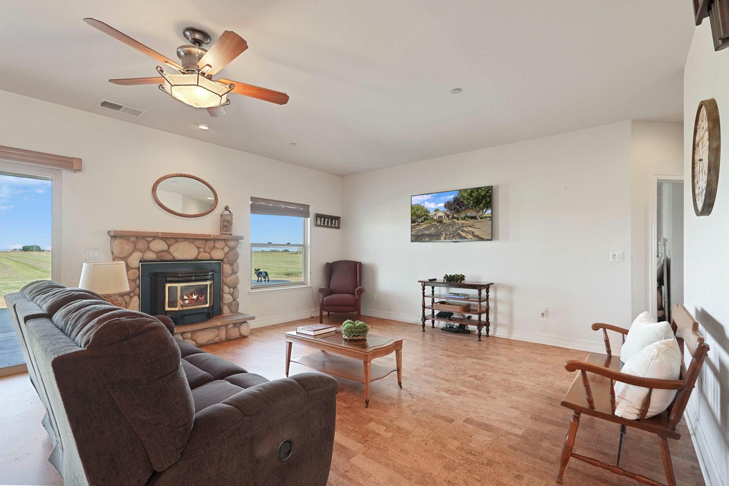 6120 Eschinger Road Elk Grove, CA 95757 - Photo 12 of 39 a living room with furniture a fireplace and window