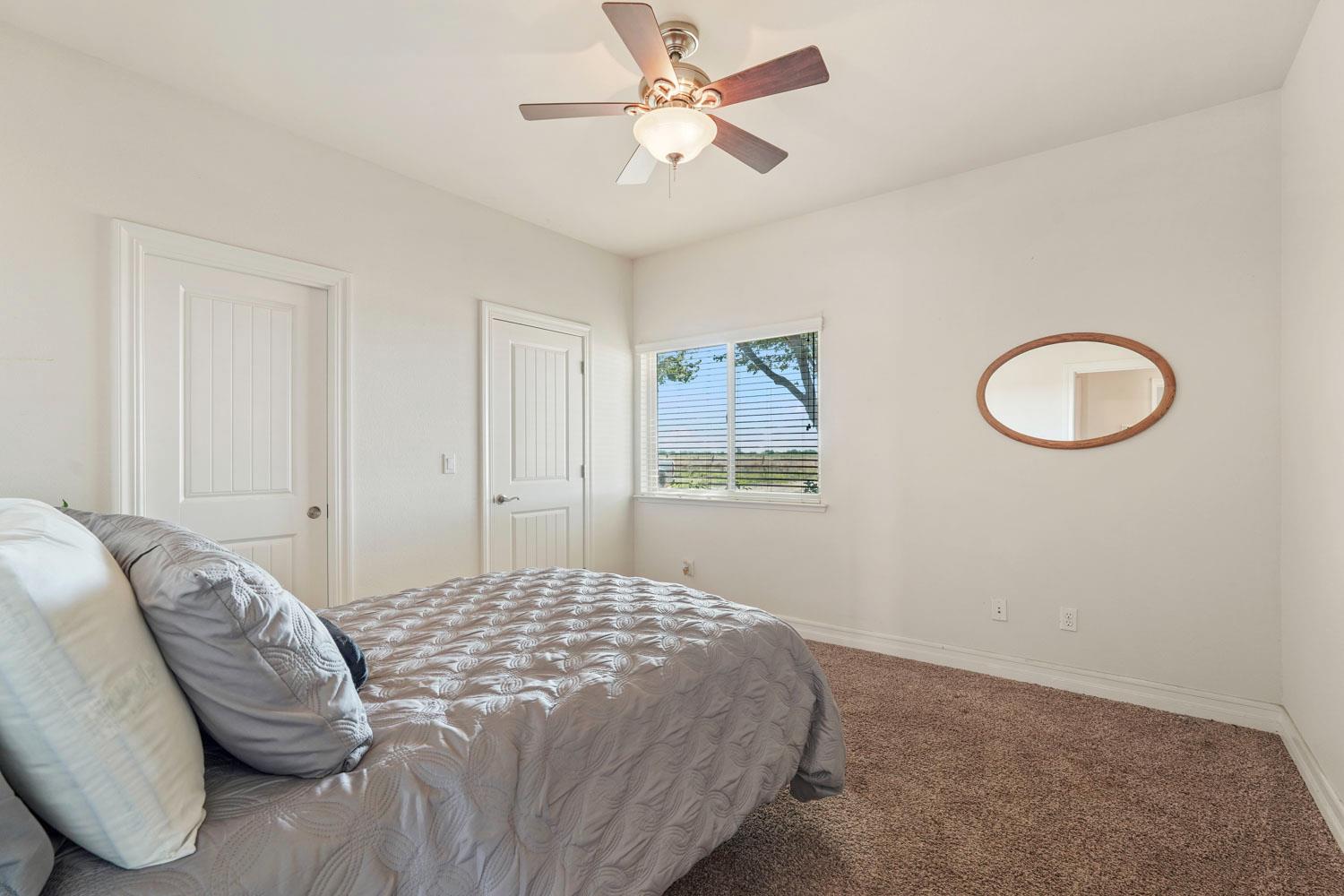 6120 Eschinger Road Elk Grove, CA 95757 - Photo 13 of 39 a bedroom with a bed chandelier and a window