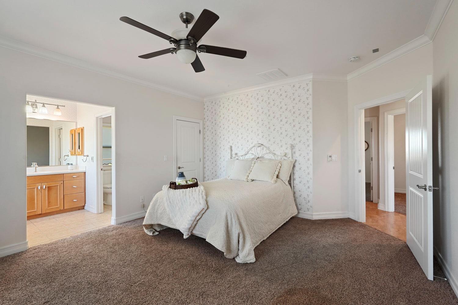 6120 Eschinger Road Elk Grove, CA 95757 - Photo 18 of 39 a bedroom with a bed and a chandelier