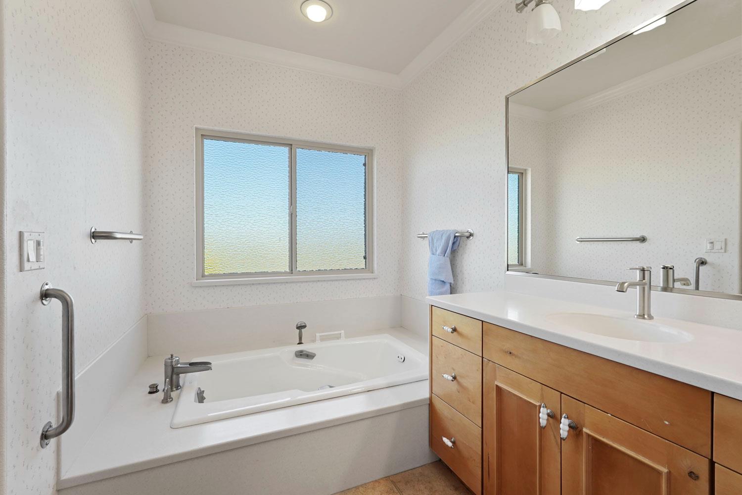 6120 Eschinger Road Elk Grove, CA 95757 - Photo 21 of 39 a bathroom with a tub sink and mirror