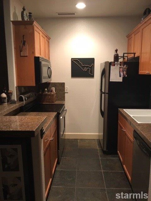 3681 Warren Way, Unit C Reno, NV 89509 - Photo 5 of 11 a kitchen with a sink stove and refrigerator