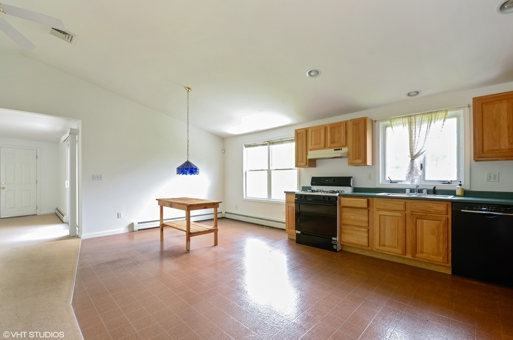 39 Boston Hill Road Fairhaven, MA 02719 - Photo 8 of 16 a living room with stainless steel appliances granite countertop a stove top oven a sink dishwasher and a stove with wooden floor