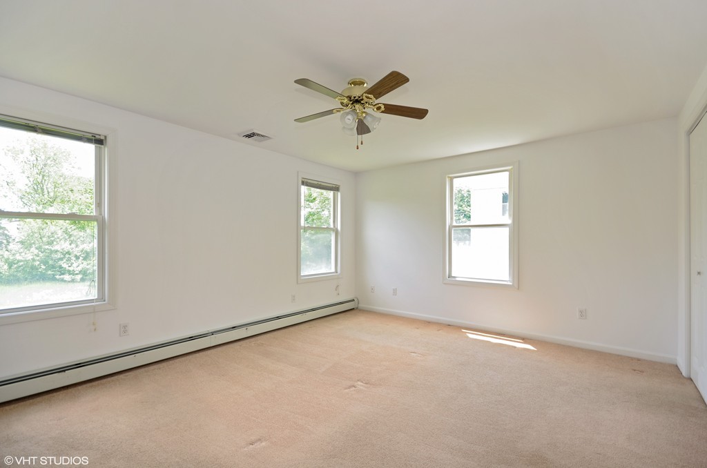 39 Boston Hill Road Fairhaven, MA 02719 - Photo 10 of 16 an empty room with windows and fan