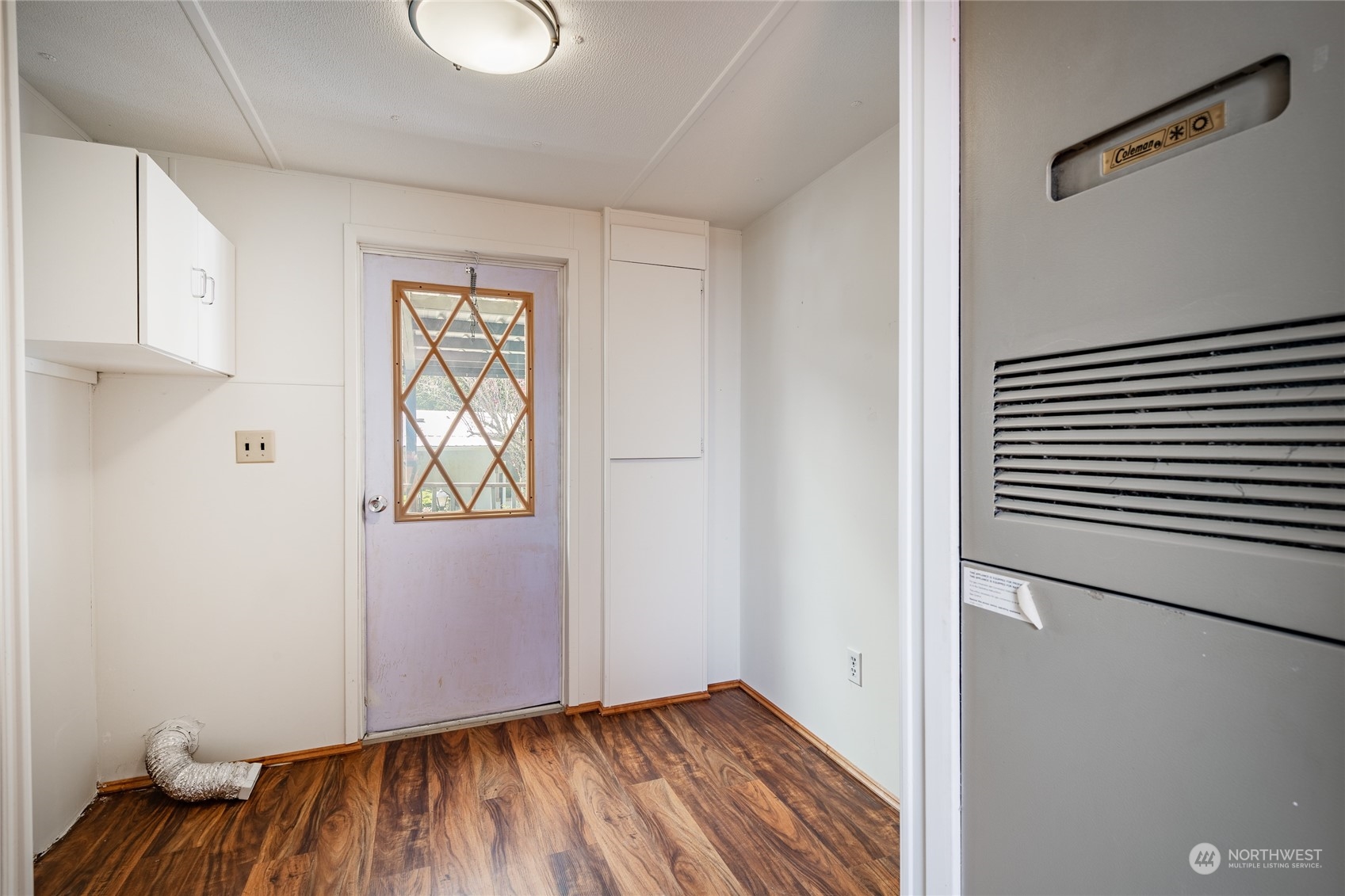 4915 Samish Way, Unit 7 Bellingham, WA 98229 - Photo 7 of 26 a view of an empty room with wooden floor and a window