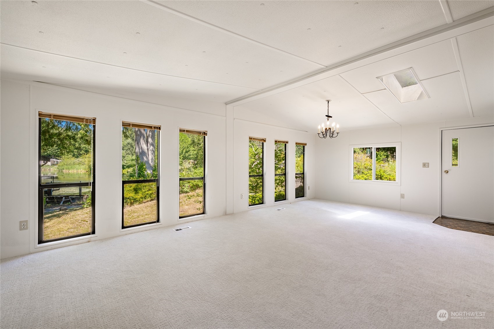 4915 Samish Way, Unit 7 Bellingham, WA 98229 - Photo 8 of 26 a view of an empty room with a fireplace and a window