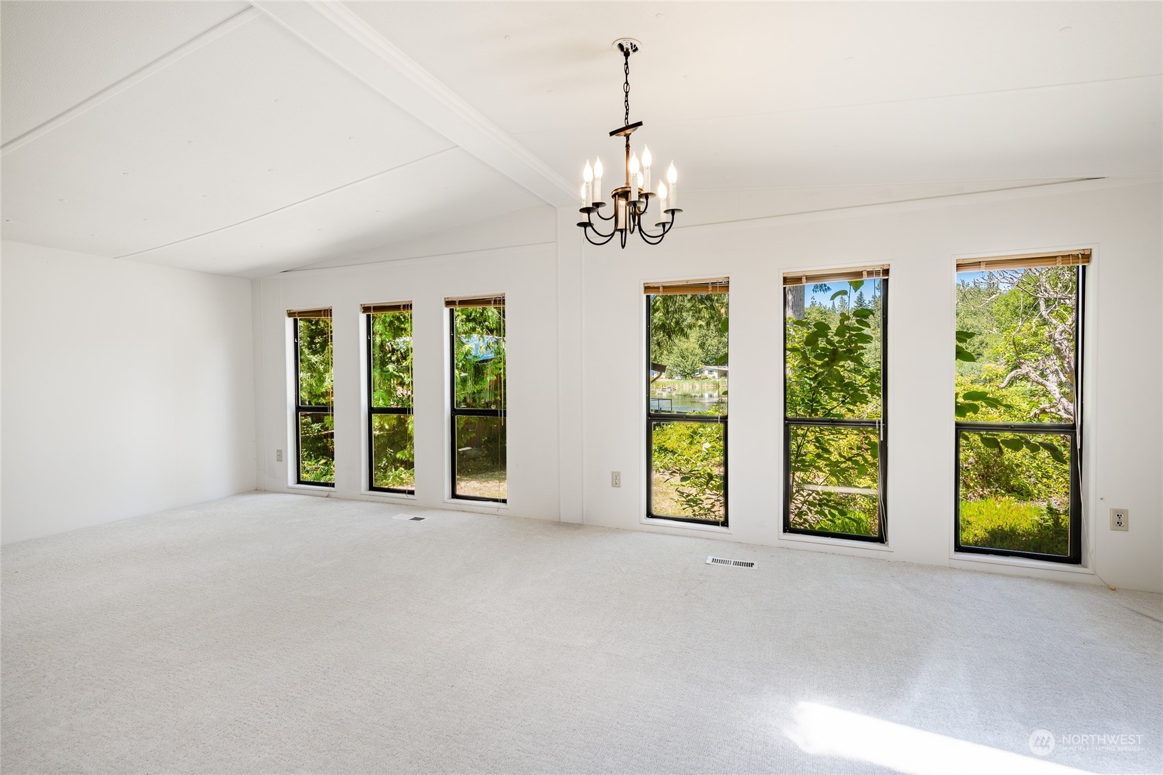 4915 Samish Way, Unit 7 Bellingham, WA 98229 - Photo 9 of 26 a view of an empty room with windows and chandelier