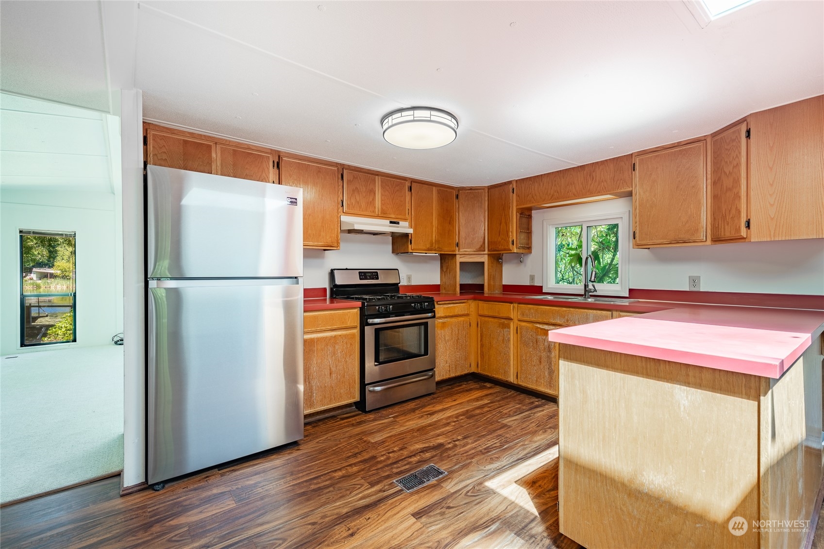 4915 Samish Way, Unit 7 Bellingham, WA 98229 - Photo 10 of 26 a kitchen with a refrigerator sink and cabinets