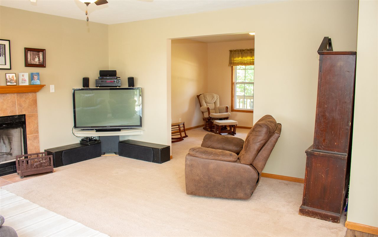 5654 Tipple Road Rockford, IL 61102 - Photo 7 of 33 a living room with furniture and a flat screen tv