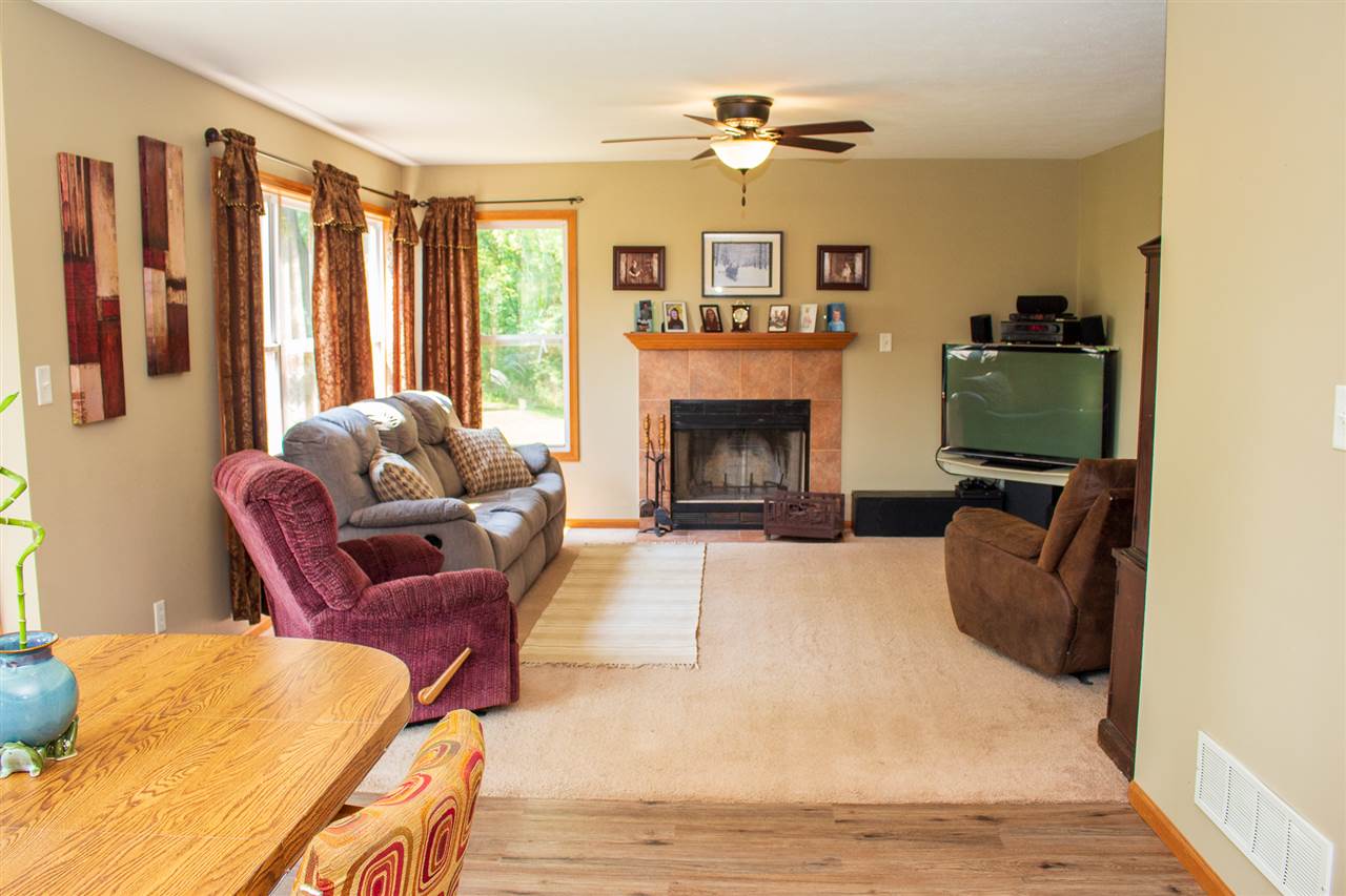 5654 Tipple Road Rockford, IL 61102 - Photo 8 of 33 a living room with furniture a flat screen tv and a fireplace