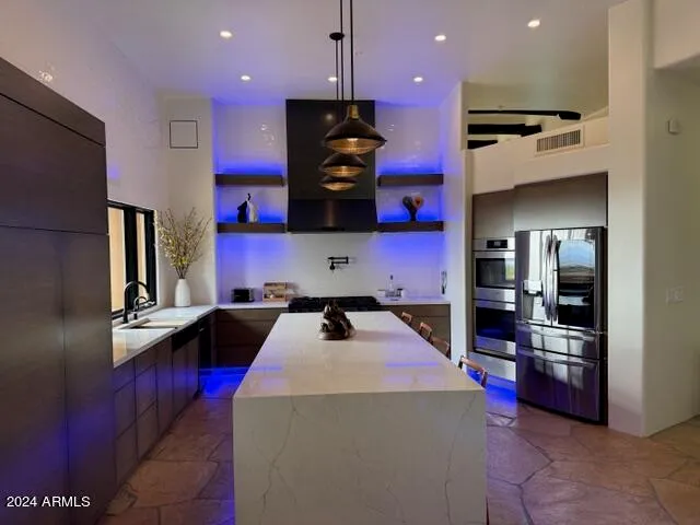 a kitchen view with wooden floor and electronic appliances