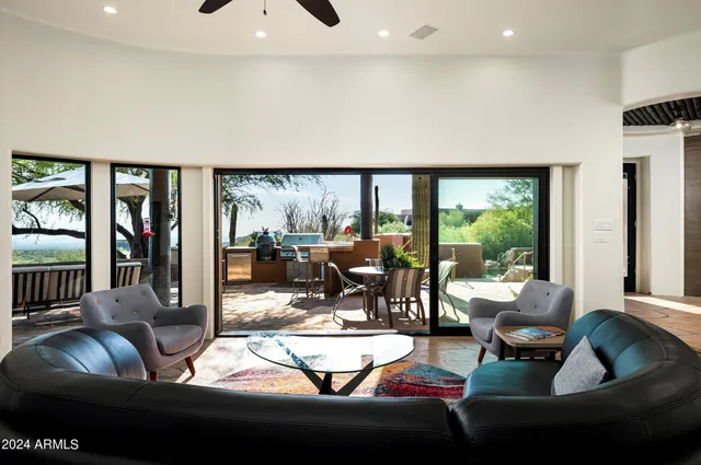 a living room with furniture a rug and a chandelier