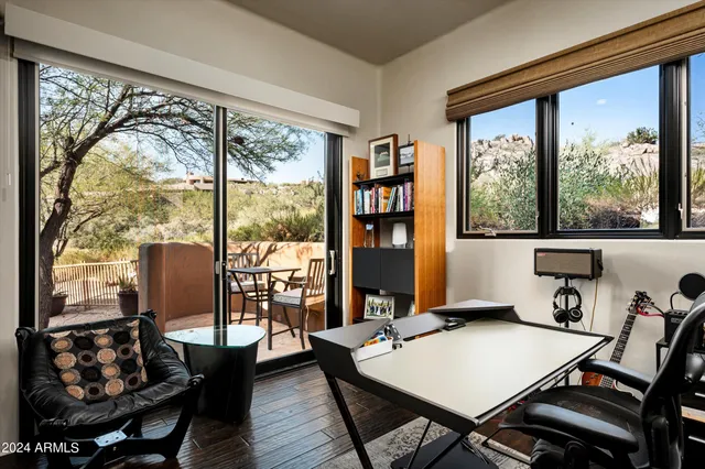 a view of a patio with table and chairs and potted plants
