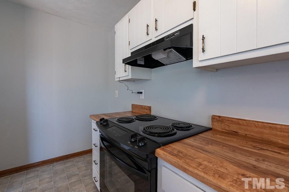 2437 Tusket Court Raleigh, NC 27613 - Photo 13 of 30 a stove top oven sitting inside of a kitchen