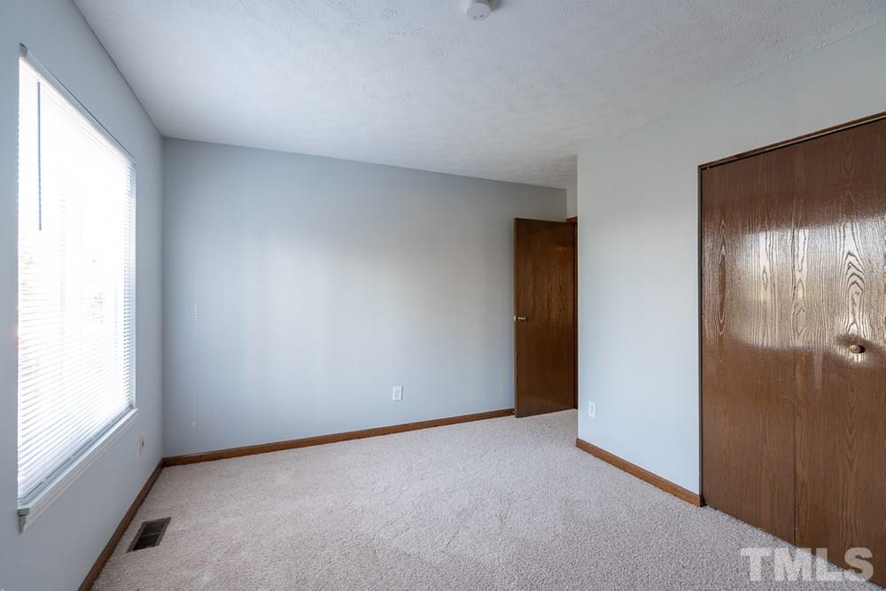 2437 Tusket Court Raleigh, NC 27613 - Photo 16 of 30 an empty room with windows and closet