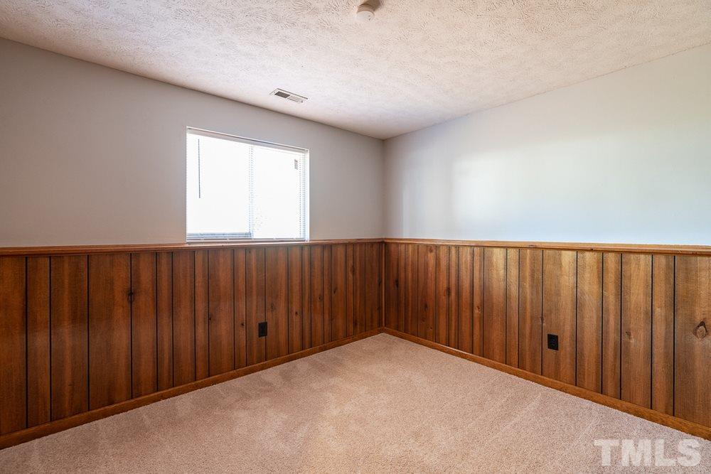 2437 Tusket Court Raleigh, NC 27613 - Photo 21 of 30 an empty room with wooden floor