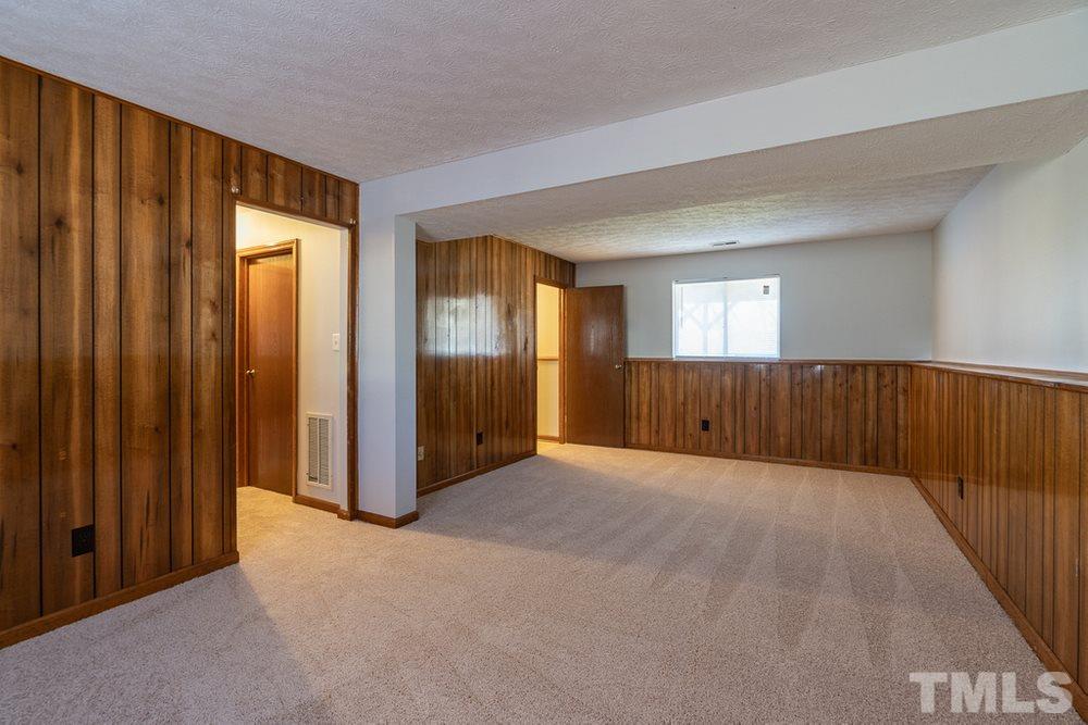 2437 Tusket Court Raleigh, NC 27613 - Photo 25 of 30 an empty room with windows and closet