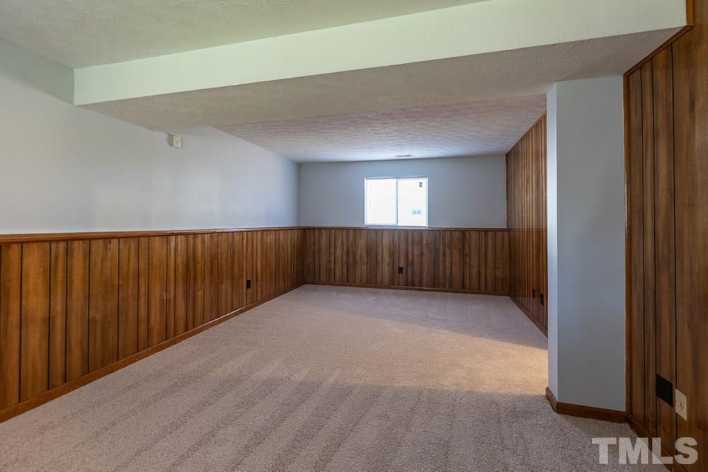 2437 Tusket Court Raleigh, NC 27613 - Photo 27 of 30 an empty room with wooden floor and windows