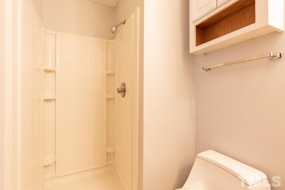 2437 Tusket Court Raleigh, NC 27613 - Photo 28 of 30 a bathroom with a toilet and shower