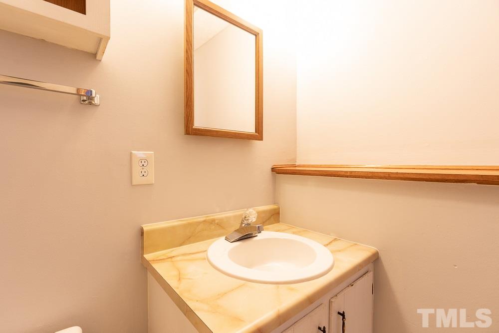 2437 Tusket Court Raleigh, NC 27613 - Photo 29 of 30 a bathroom with a sink and a mirror