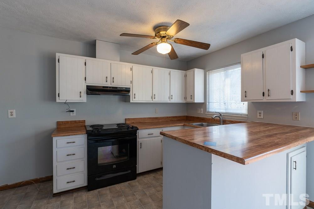 2437 Tusket Court Raleigh, NC 27613 - Photo 10 of 30 a kitchen with cabinets appliances and a window