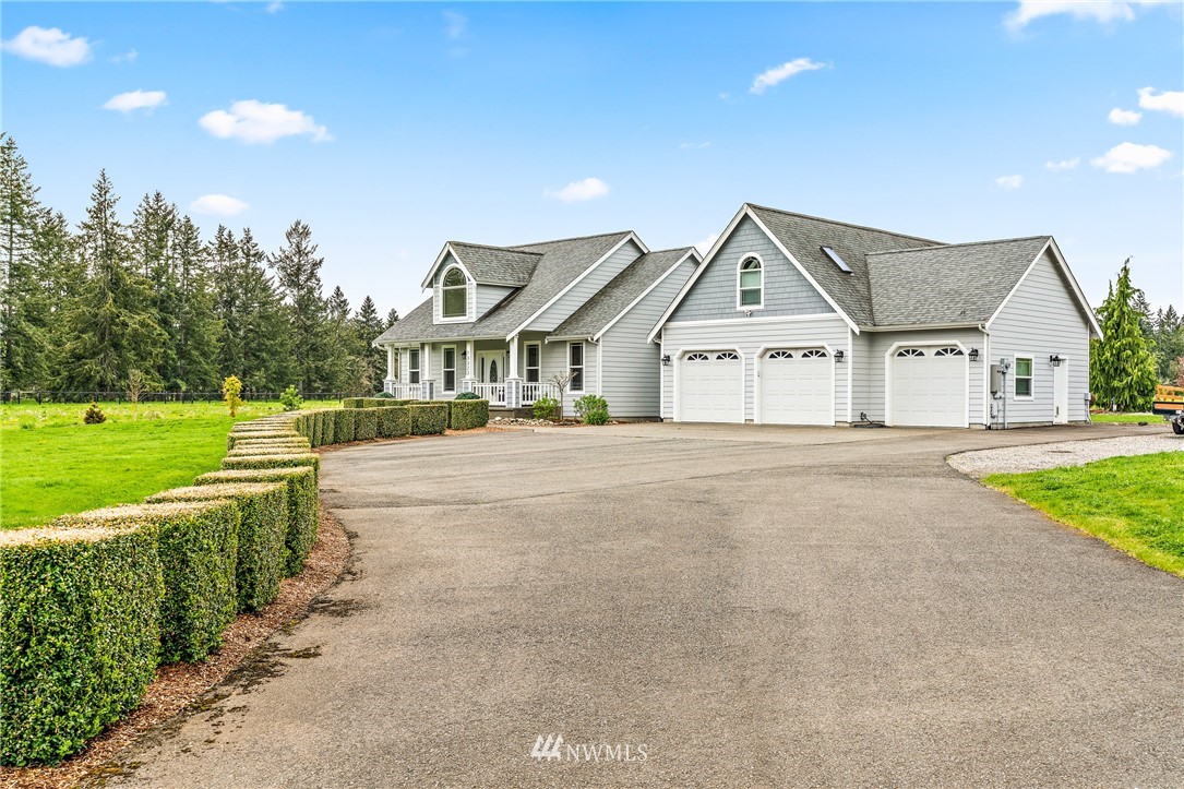 13323 Erskine Road Southwest Rochester, WA 98579 - Photo 1 of 30 a front view of a house with a yard and garage