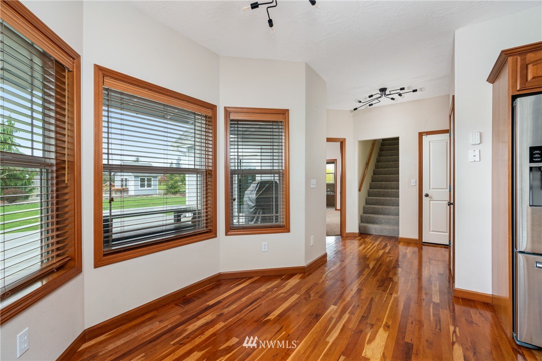 13323 Erskine Road Southwest Rochester, WA 98579 - Photo 11 of 30 a view of an empty room with wooden floor and a window