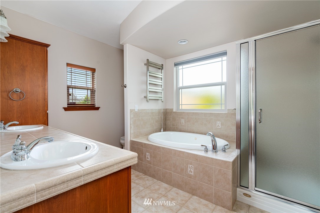 13323 Erskine Road Southwest Rochester, WA 98579 - Photo 16 of 30 a bathroom with a tub sink and mirror