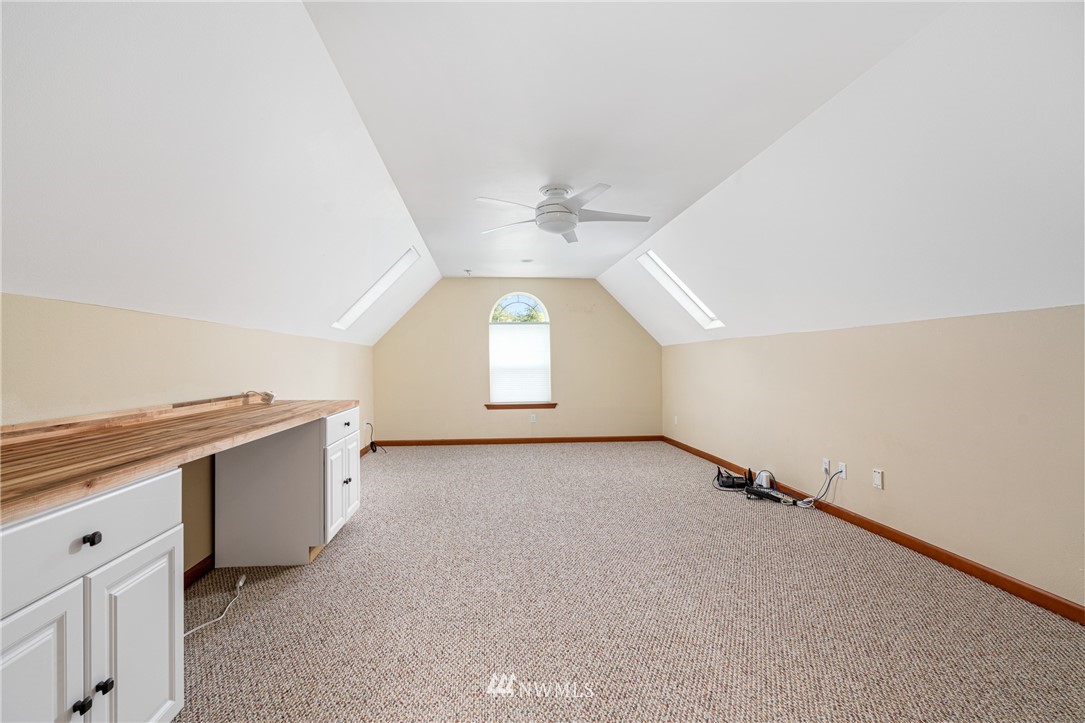 13323 Erskine Road Southwest Rochester, WA 98579 - Photo 18 of 30 an empty room with a ceiling fan and window